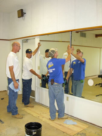 dance studio Casey,Carlos and Tyler installing a mirrored wall