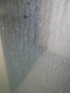 how do I clean hard water on a glass shower door